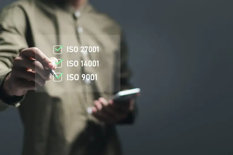 ISO concept. Businessman makes a checklist for standards iso 27001 Information Security Management System-ISMS, ISO 14001 environmental management system-EMS and ISO 9001 Quality Management System-QMS